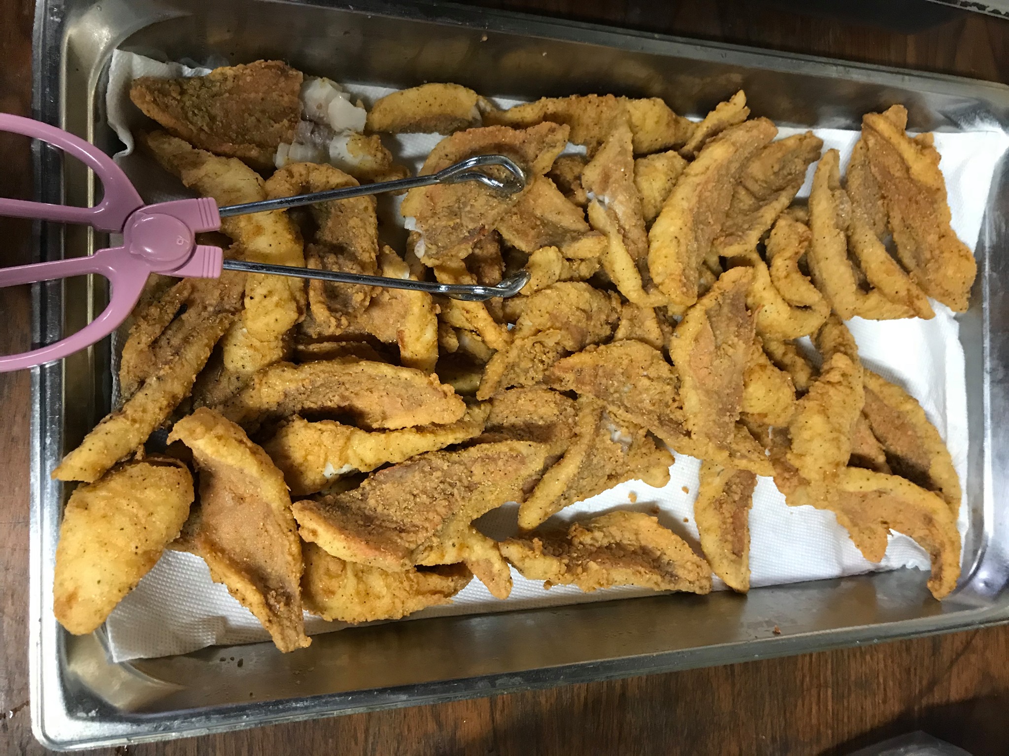 fried fish in a large pan