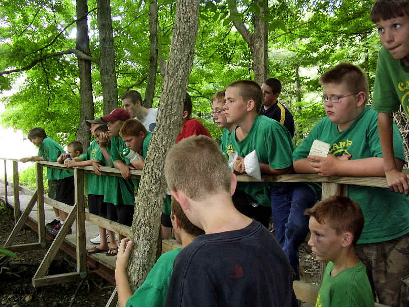 Boy campers standing on a bridge